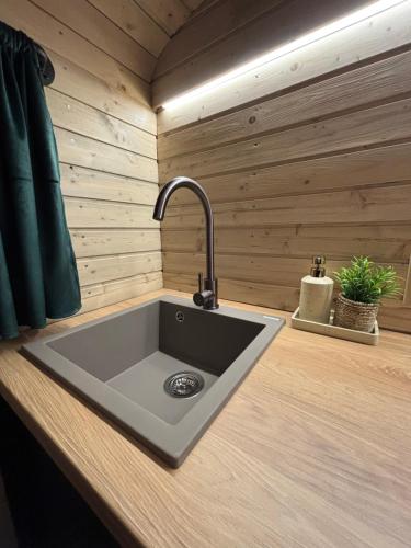 a kitchen counter with a sink in a room at Glamping Vejtřaska in Mochtín