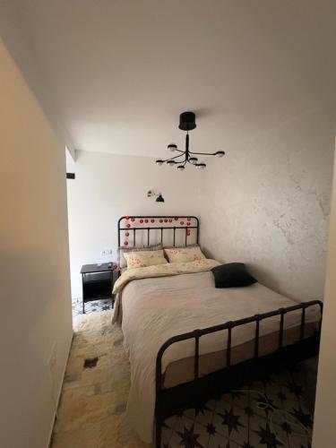 a bedroom with a bed and a ceiling fan at Apartman Lala in Nova Varoš