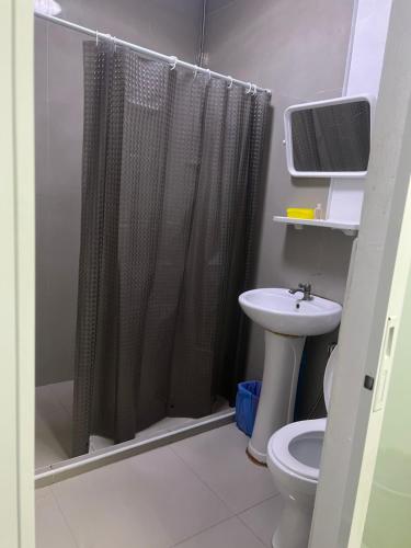 a bathroom with a shower curtain and a sink at Escobar guest house jomtien in Ban Nong Tabaek