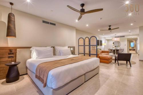 a bedroom with a large bed and a living room at The Rabat Viewpoint Suites by 360 Estates in Ħal-Bajjada