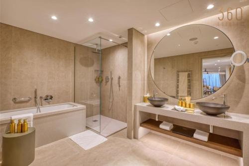 a bathroom with two sinks and a tub and a mirror at The Rabat Viewpoint Suites by 360 Estates in Ħal-Bajjada