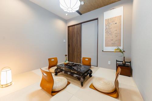 a living room with a table and chairs at Kyoto Amazing The Wizarad of Oz in Kyoto