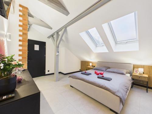 a bedroom with a bed and some skylights at Romantic Studio Marki LoveAparts in Marki