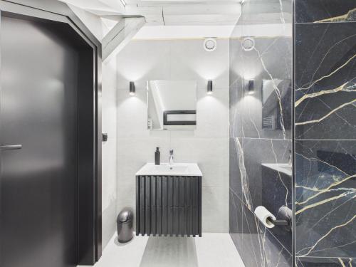 a bathroom with a sink and a mirror at Romantic Studio Marki LoveAparts in Marki