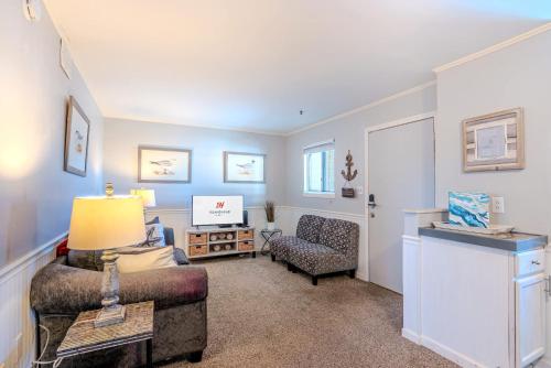 a living room with a couch and a chair at Resort Retreat - Multiple Pools - Beach Access in Hilton Head Island