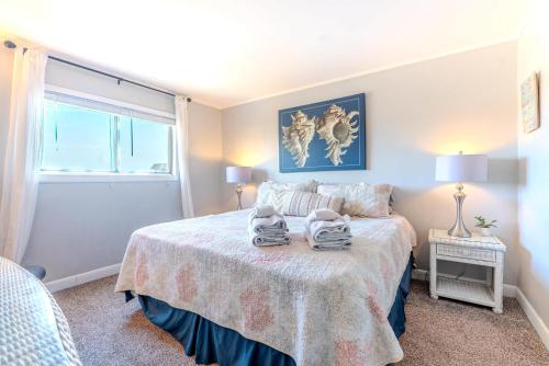 a bedroom with a bed with two towels on it at Resort Retreat - Multiple Pools - Beach Access in Hilton Head Island