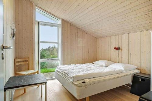 a bedroom with a bed in a room with a window at JB406-Fjerritslev-Aspevej-68 in Fjerritslev