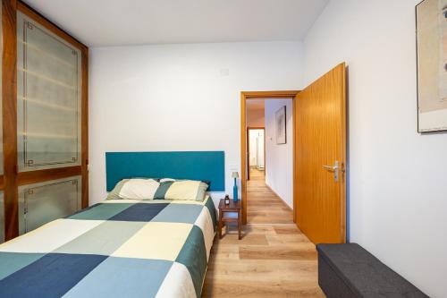 a bedroom with a bed and a door to a hallway at Eco Home - Val di Luce in Abetone