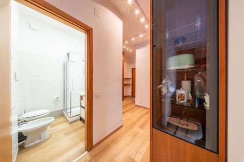 a bathroom with a toilet and a sink and a mirror at Eco Home - Val di Luce in Abetone