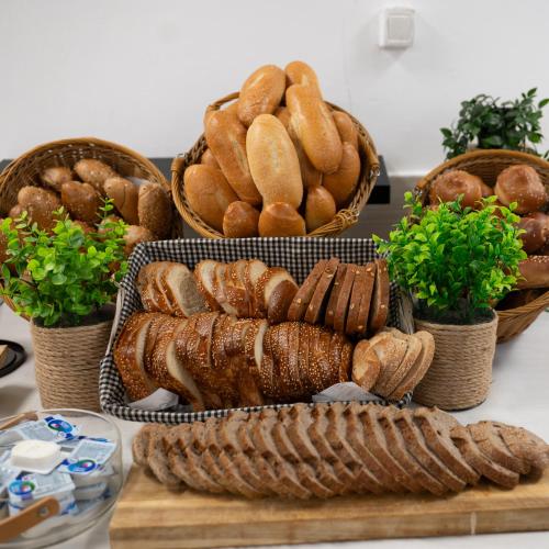 three baskets of bread and buns on a table at Nofey HaBashan Country Lodge in Lahavot HaBashan
