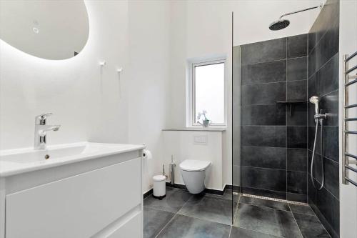 a white bathroom with a sink and a toilet at 20514-Samso-Plantagevej-17 in Sælvig