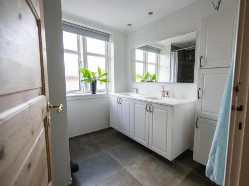 a bathroom with a sink and a mirror at Sdr. Omme Bed & Breakfast in Sønder Omme