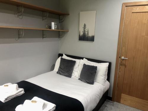 a bedroom with a bed with white sheets and pillows at Bassett Home - Double room and Free Parking in Southampton