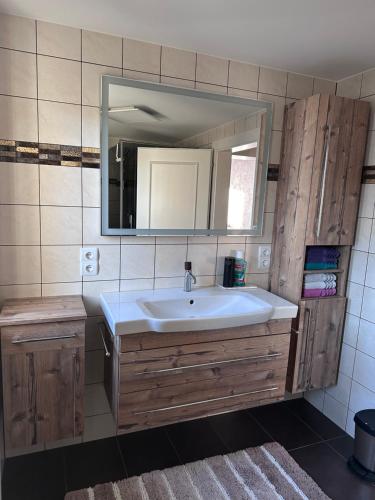 a bathroom with a sink and a mirror at Bright & Cozy Apartment in Villach
