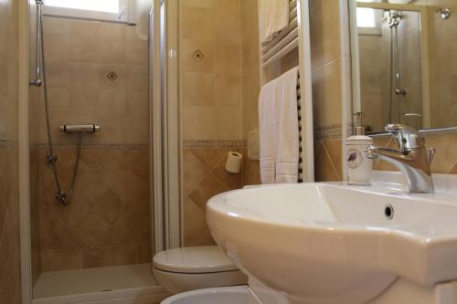 a bathroom with a sink and a toilet and a shower at Casa Maria in Monterosso al Mare