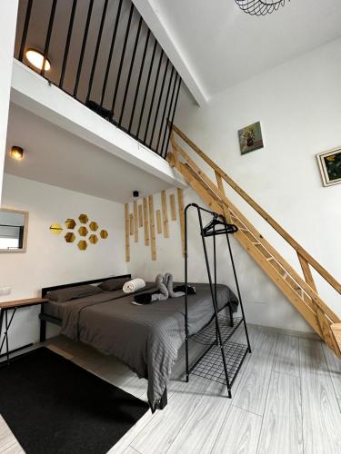 a bedroom with a bed and a staircase at ANA City Rooms in Cluj-Napoca