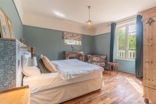 a bedroom with a bed and a chair in it at Bon Chez Nous in Saint-Amand-Jartoudeix