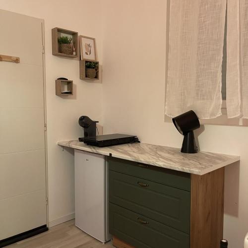 a kitchen with a counter with a black appliance on it at Love room - Montélimar in Montélimar