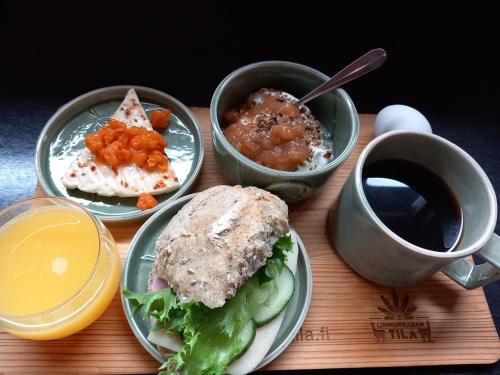 a table with plates of food and a cup of coffee at Nature resort Linnunrata in Oulu