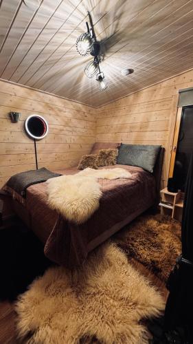 a bedroom with a bed with a shag rug at Nature resort Linnunrata in Oulu