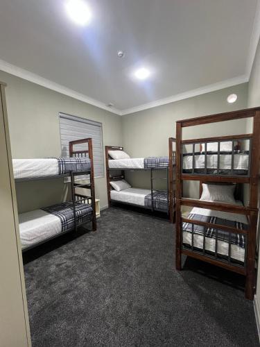 a room with three bunk beds in it at Hostel Mevazor in Katartal
