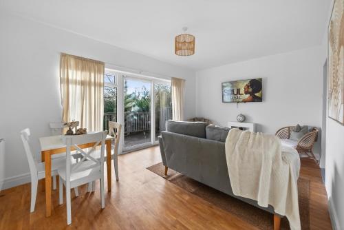 a living room with a couch and a table at Ty Sage in Pembrokeshire