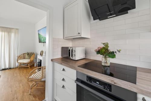 a kitchen with a counter top with a microwave at Ty Sage in Pembrokeshire