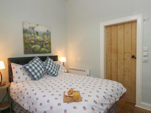 a bedroom with a bed with a box on it at Ardpatrick South Lodge in Tarbert