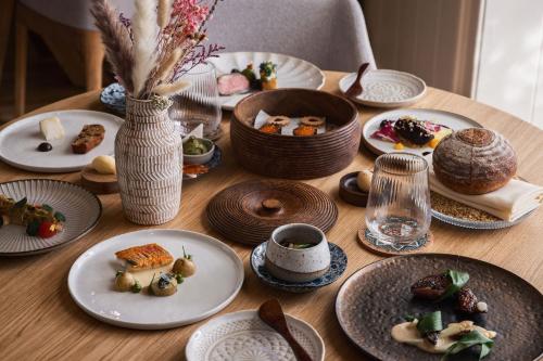 a wooden table with plates of food on it at Tyddyn Llan Restaurant with Rooms in Corwen