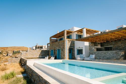 a villa with a swimming pool and a house at Sunset Heaven Villa on Kea in Korissia