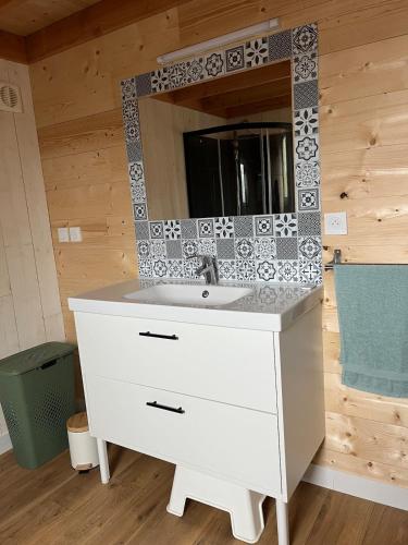 a bathroom with a white sink and a mirror at ty loft keremma in Tréflez