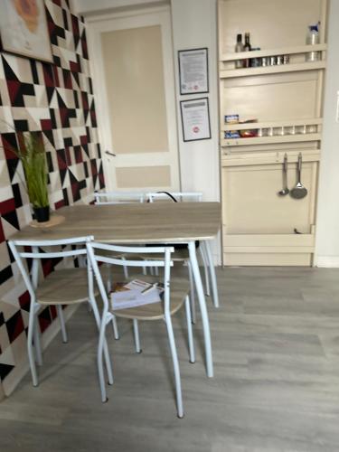 a dining room with a table and chairs at Chez Elie in Saintes