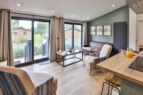 a living room with a couch and a table at Blenheim Palace Lodge Retreat in Woodstock