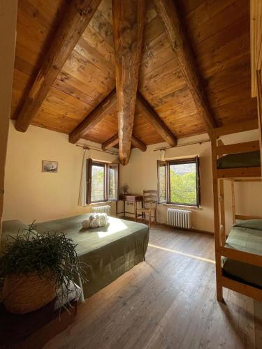 a bedroom with a bed in a room with wooden ceilings at CASA VACANZE per Famiglie Agriturismo Montepolo in Canavaccio di Urbino