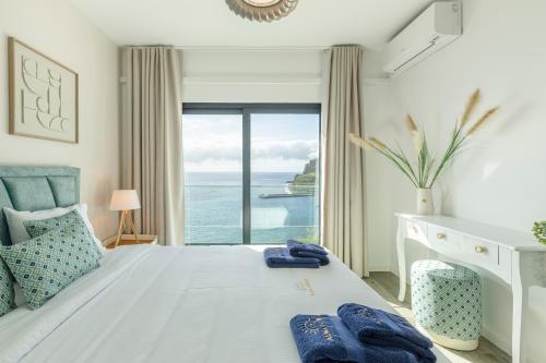 a bedroom with a bed with a view of the ocean at Alma do mar luxury - Ocean front in Gaula