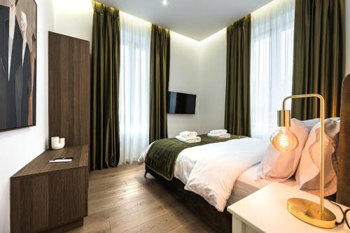 a hotel room with a bed and a desk at Lithos Boutique Residences in Volos