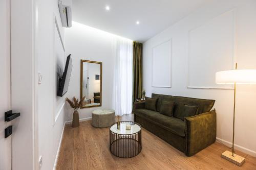 a living room with a couch and a table at Lithos Boutique Residences in Volos
