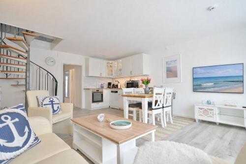 a living room with a kitchen and a dining room at Küstenkinder Whg 17 in Kellenhusen