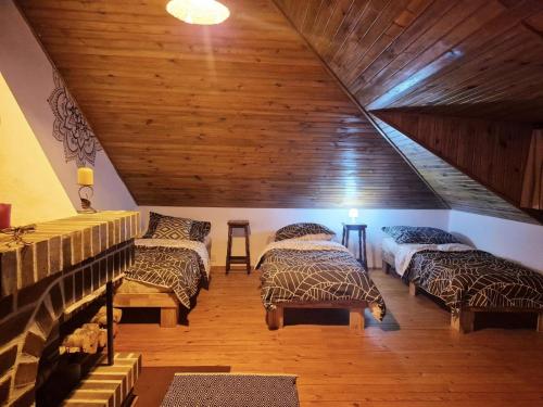 a attic room with three beds and a staircase at Siedlisko Bliss Garden Retreat House ZielonoMi in Lengenquell