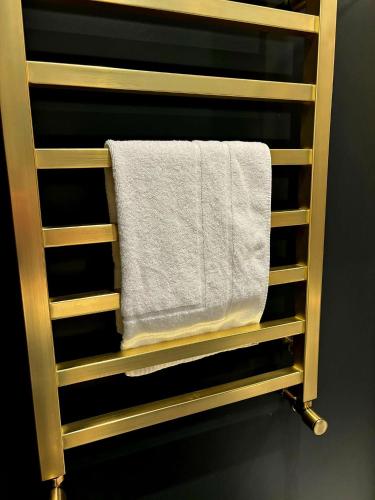a towel rack with a white towel on it at Hamilton Luxury - The James Suite in Scorton