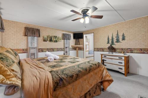a bedroom with a bed and a ceiling fan at Prairie Creek Cabin Getaway in Rapid City