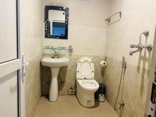 a small bathroom with a toilet and a sink at RJ Hotel Pokhara in Pokhara