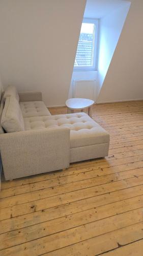 a bed sitting on a wooden floor in a room at Privatzimmer Hagen in Hagen