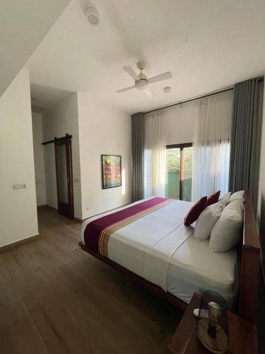 a bedroom with a large bed and a window at Lush Garden Chalet in Afiaman