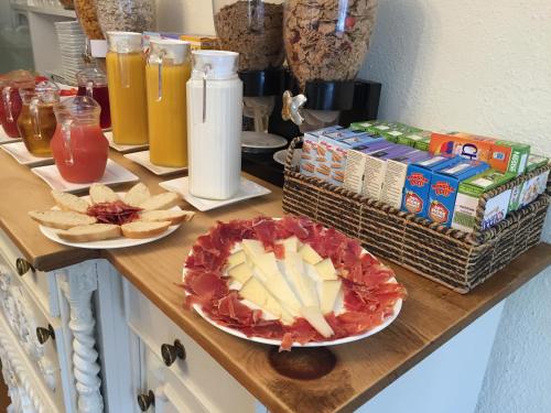 a counter with two plates of food and snacks at Chester House Guest House in Chester