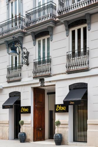 a building with black awnings on the side of it at Blanq Gran vía in Valencia
