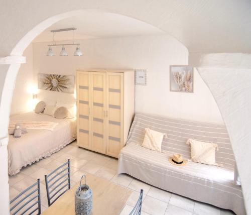 a living room with two beds and a couch at Studio confort, chic & spacieux Plage de Juan les pins & central in Juan-les-Pins