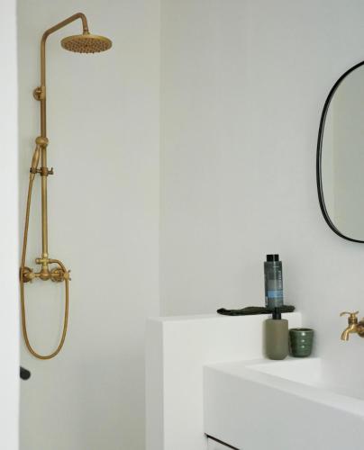 a bathroom with a shower and a mirror at Huis Prins in Prince Albert
