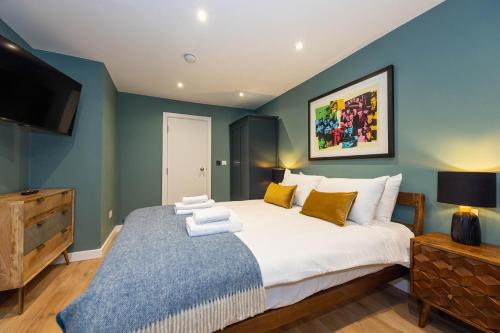 a bedroom with a large bed and a flat screen tv at Host & Stay - Canning Quarters in Liverpool