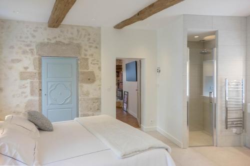 a bedroom with a white bed and a walk in shower at Le Clos du XVIe - Exceptional accommodation in Orléans